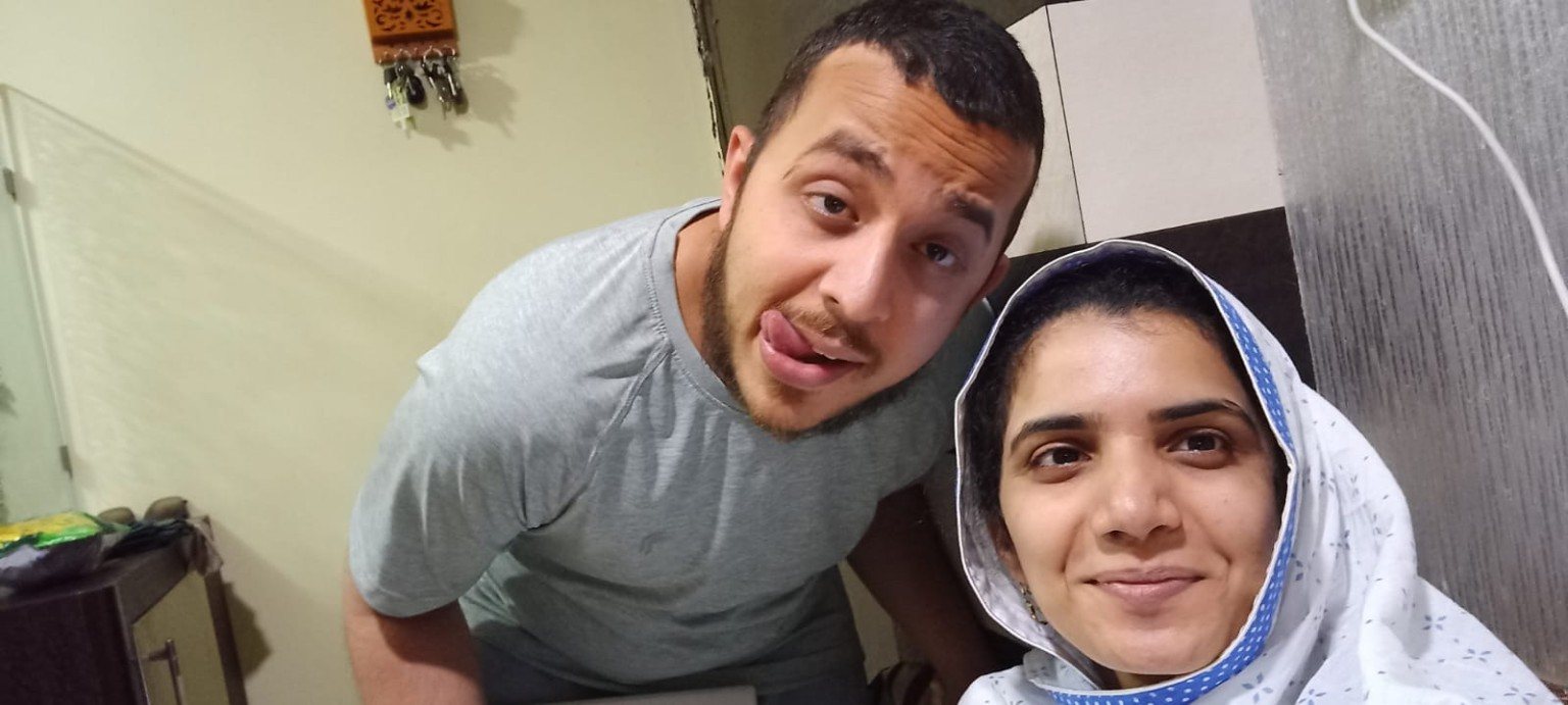 Mariya and Burhanuddin taking a selfie on the sofa