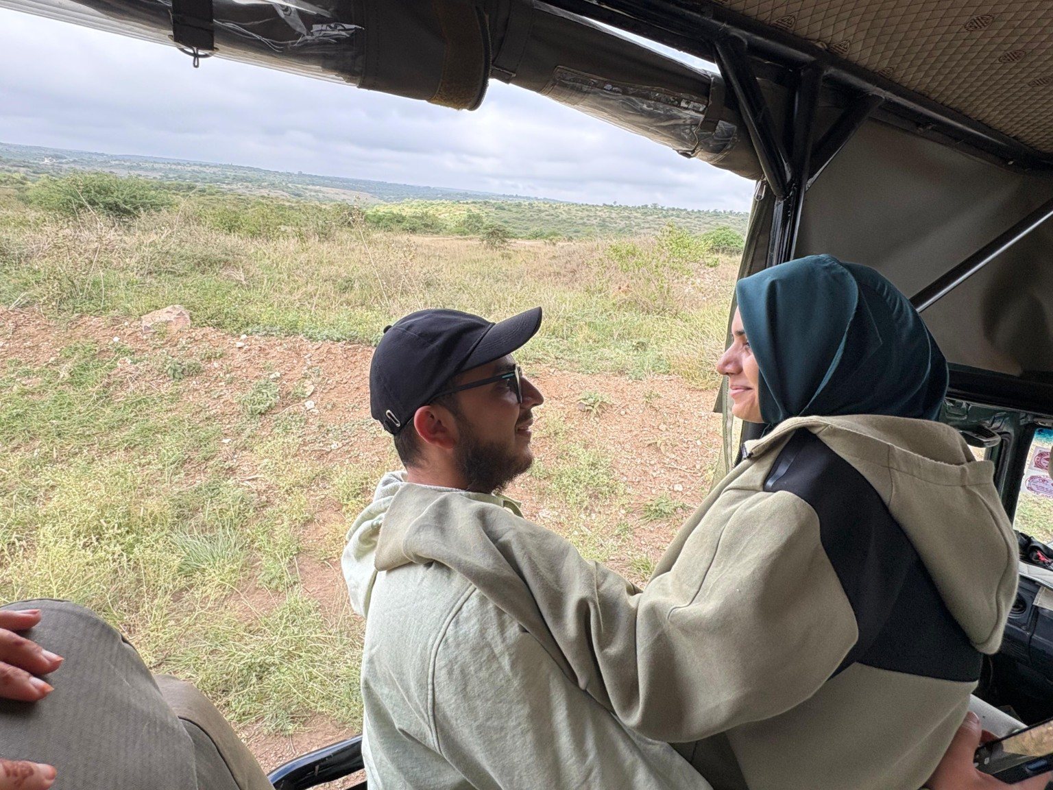 Mariya and Burhanuddin sitting together in a safari jeep in Nairobi