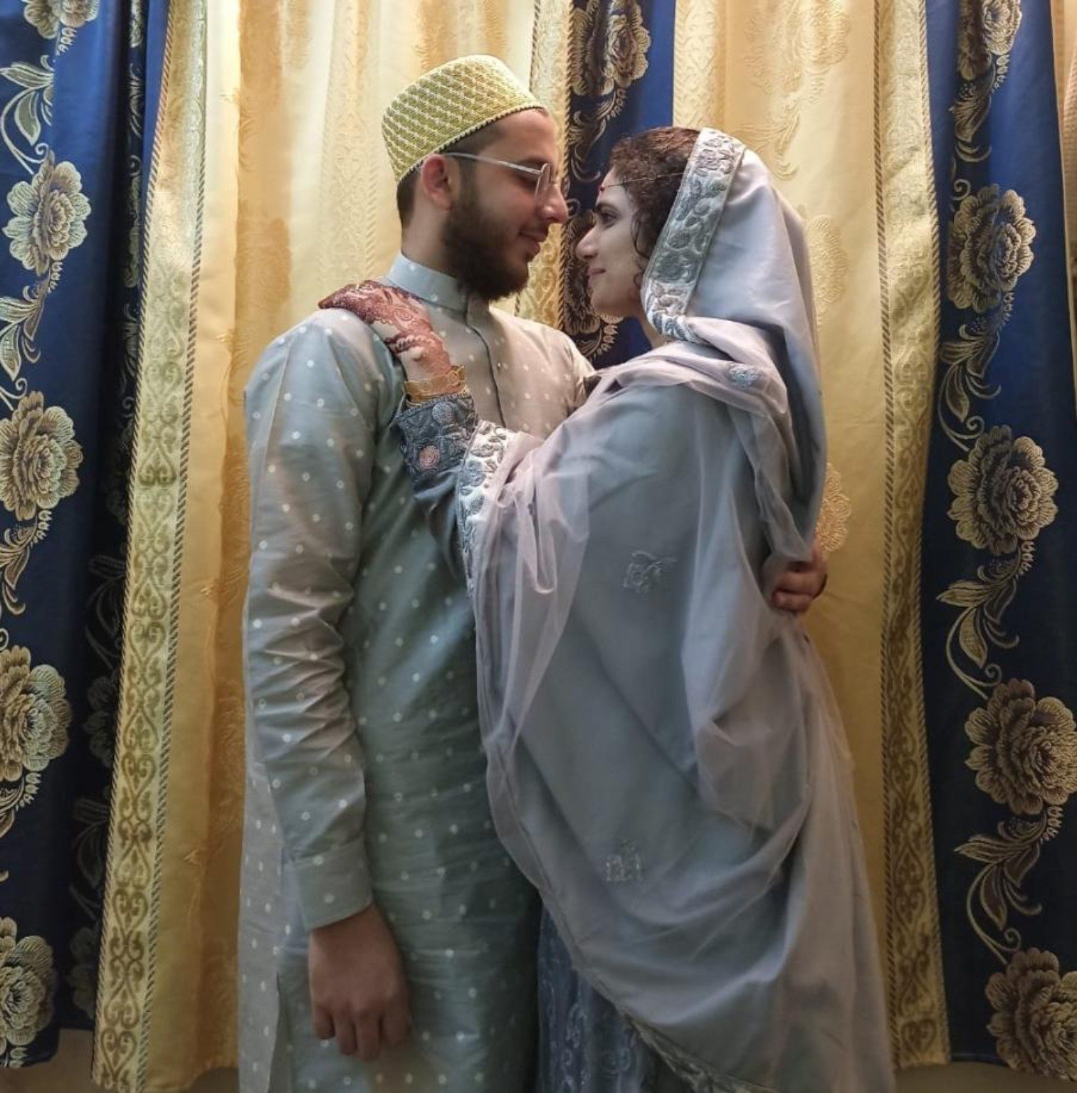 Mariya and Burhanuddin standing closely together