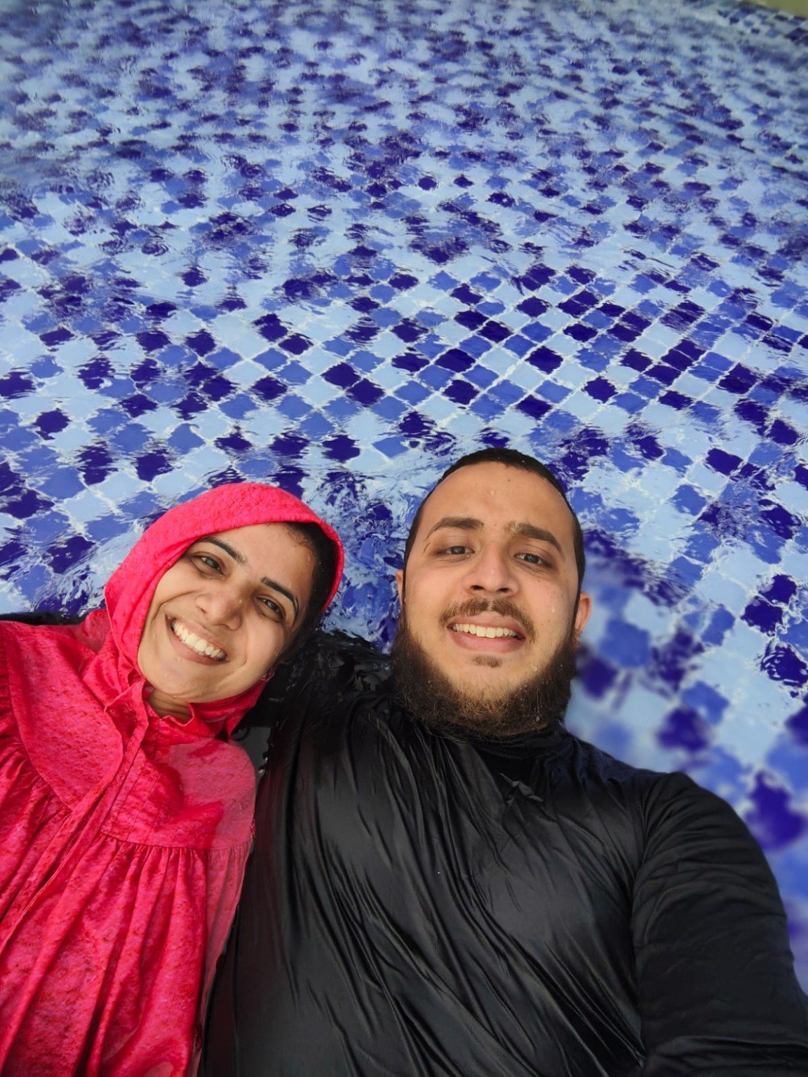 Mariya and Burhanuddin smiling in a pool